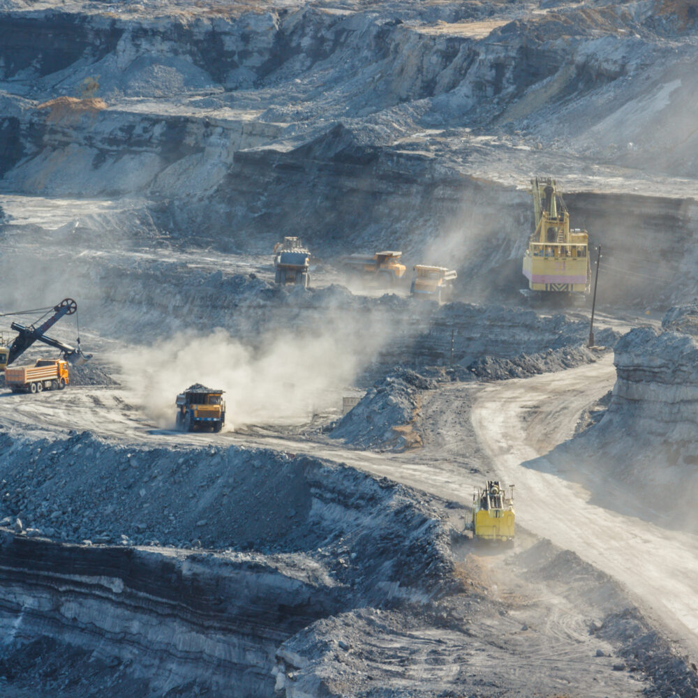 Mining concept with multiple road consolidation vehicles moving raw materials.