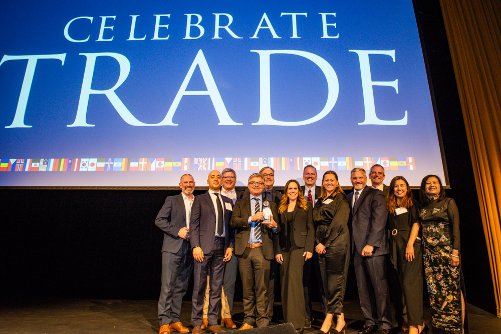 OIA Global employees celebrating their trade award from the Oregon Consular Corps at the annual trade gala.