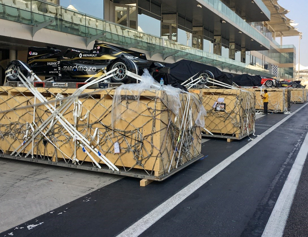Automotive and mobility operations showing formula one F1 racecars above boxes before loading into plane.