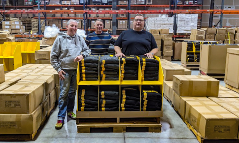 Point of purchase retail display with black and yellow apparel inside a store.